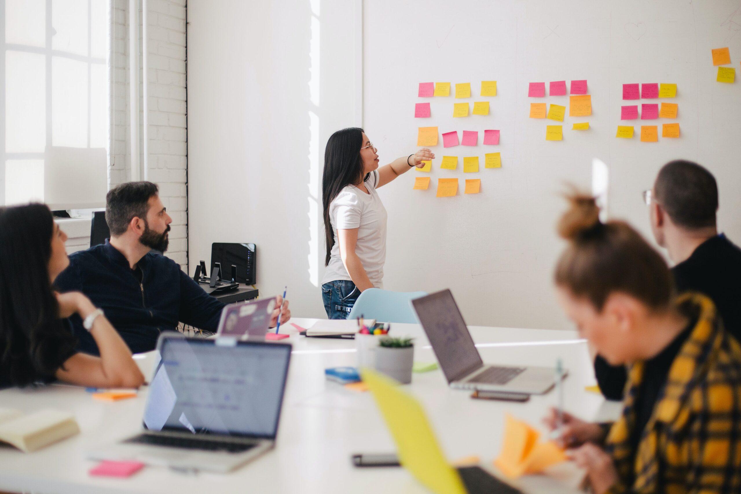 A woman leading employees in a training session in an office.